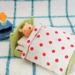 リスがベッドで寝ている羊毛フェルトの立体イラスト