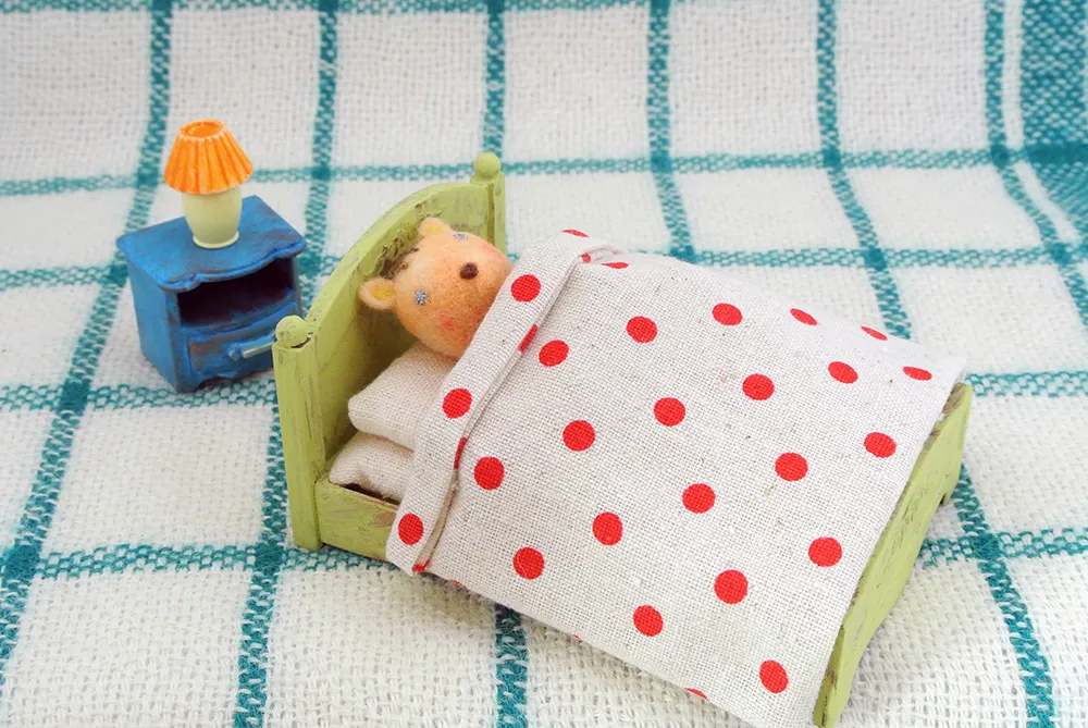 リスがベッドで寝ている羊毛フェルトの立体イラスト